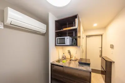 a kitchen with a sink and a microwave at 201 Direct access to Narita Haneda 5-minute walk to Keikyu Kamata Station, with kitchen, ideal for telework, apartment in Tokyo