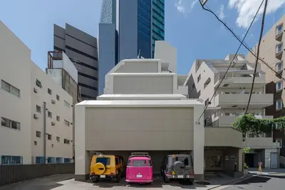 three vehicles parked in a parking lot in a city at Shibuya E-address 205 in Tokyo