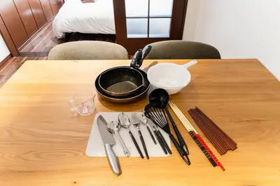 a table with utensils on a wooden table at Shibuya E-address 205 in Tokyo