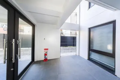 a garage with a fire hydrant in front of a door at 401 Direct to Narita Haneda 5-minute walk from Keikyu Kamata Station with kitchen, ideal for telework, apartment in Tokyo