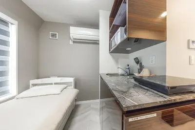 a kitchen with a counter and a sink in a room at 401 Direct to Narita Haneda 5-minute walk from Keikyu Kamata Station with kitchen, ideal for telework, apartment in Tokyo
