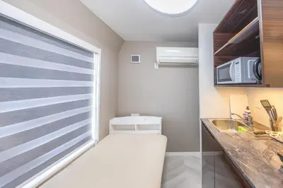 a small kitchen with a sink and a window at 401 Direct to Narita Haneda 5-minute walk from Keikyu Kamata Station with kitchen, ideal for telework, apartment in Tokyo