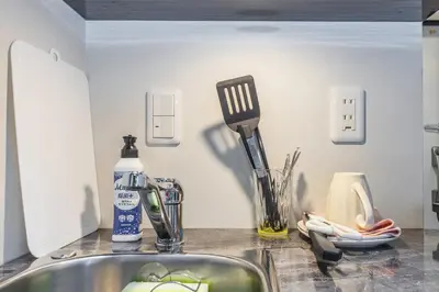 a kitchen counter with a sink and utensils at 401 Direct to Narita Haneda 5-minute walk from Keikyu Kamata Station with kitchen, ideal for telework, apartment in Tokyo