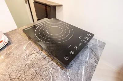a remote control sitting on top of a counter at 402 Direct access to Narita Haneda 5-minute walk from Keikyu Kamata Station with kitchen, ideal for telework, apartment in Tokyo