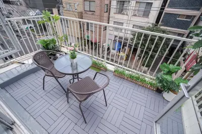 a patio with a table and chairs on a balcony at 3 minutes to Shinjuku by subway-Nakanokaikan III in Tokyo