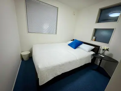 a small bedroom with a white bed and a window at Entire house, 3 minutes on foot from Ekoda station, 2 stations by train to Harry Potter, direct access to Ikebukuro,Shinjuku,Shibuya,Roppongi in Tokyo