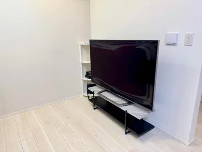 a flat screen tv sitting on a stand in a room at Entire house, 3 minutes on foot from Ekoda station, 2 stations by train to Harry Potter, direct access to Ikebukuro,Shinjuku,Shibuya,Roppongi in Tokyo