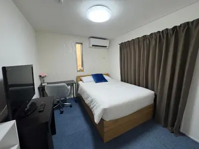 a bedroom with a bed and a desk and a television at Entire house, 3 minutes on foot from Ekoda station, 2 stations by train to Harry Potter, direct access to Ikebukuro,Shinjuku,Shibuya,Roppongi in Tokyo