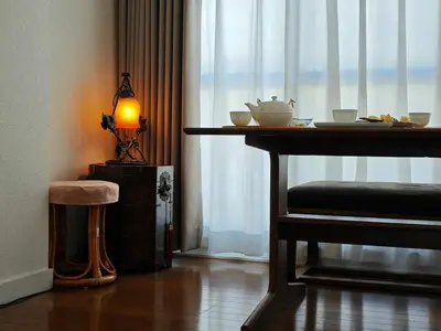a table and a stool in a room with a window at Pearl Heights 301 suit room, Easy access to Ikebukuro Shinjuku Station in Tokyo