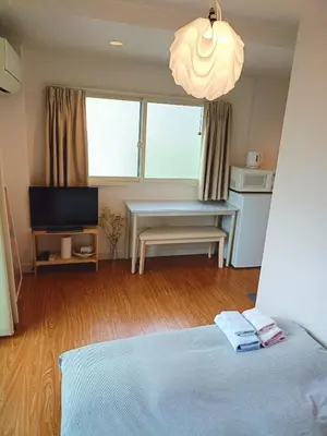 a bedroom with a bed and a desk and a television at Pearl Heights 201 Easy access to Ikebukuro Shinjuku, Cozy 1 room in Tokyo