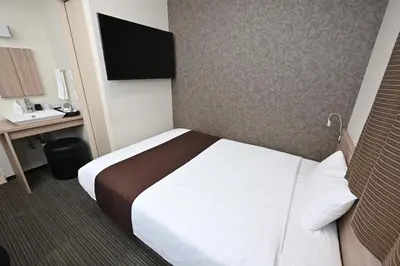 a hotel room with a bed and a desk at Sanco Inn Grande Tokyo Hamamatsucho in Tokyo