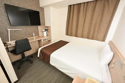 a hotel room with a bed and a desk at Sanco Inn Grande Tokyo Hamamatsucho in Tokyo