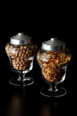 two glass vases filled with nuts and seeds on a table at Hotel New Otani Tokyo EXECUTIVE HOUSE ZEN in Tokyo
