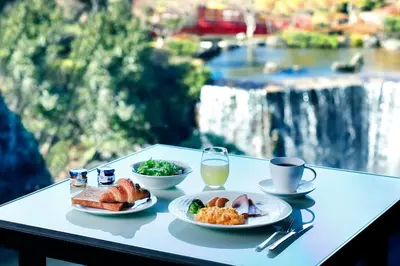 a table with two plates of food and a drink at Hotel New Otani Tokyo EXECUTIVE HOUSE ZEN in Tokyo
