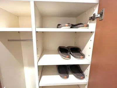 a pair of shoes on shelves in a closet at Shinjuku 10 min walk, Higashi Shinjuku 4 min, Kabukicho, Shin-Okubo apartment in Tokyo