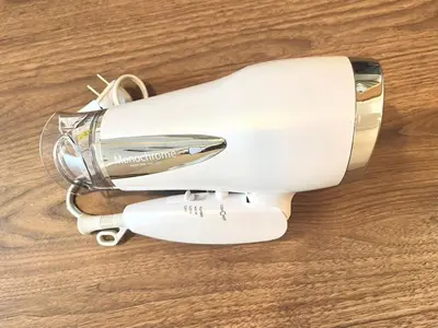 a white hair dryer sitting on a wooden table at Shinjuku 10 min walk, Higashi Shinjuku 4 min, Kabukicho, Shin-Okubo apartment in Tokyo