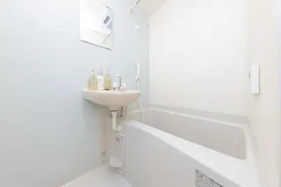 a white bathroom with a sink and a bath tub at \u30e1\u30eb\u30c7\u30a3\u30a2\u6771\u5800\u5207 in Tokyo