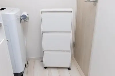 a white refrigerator in a room with a toilet at \u30e1\u30eb\u30c7\u30a3\u30a2\u6771\u5800\u5207 in Tokyo