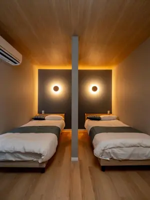 a room with three beds with lights on the wall at TOKYO STAY in Kamata in Tokyo