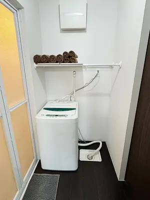 a small laundry room with a washer and dryer at Tokyo Stay Top Ikebukuro #103 in Tokyo