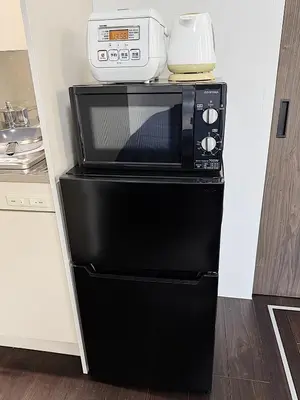 a microwave oven sitting on top of a refrigerator at Tokyo Stay Top Ikebukuro #103 in Tokyo
