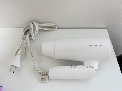 a white hair dryer sitting on a wall at Tokyo Stay Top Ikebukuro #103 in Tokyo