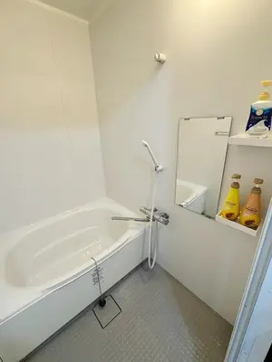 a white bathroom with a tub and a mirror at Tokyo Stay Top Ikebukuro #103 in Tokyo