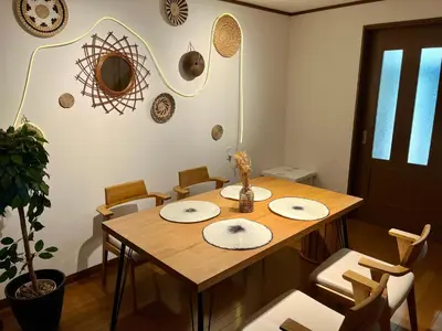 a dining room with a wooden table and chairs at GU Hotel Traditional Japanese-Style House in Tokyo15 Minutes by Train from Shinjuku Sleeps Up to 10 Guests in Tokyo
