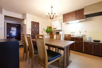 a kitchen with a wooden table and a dining room at \u9daf\u8c37 \u5bdb\u6c38\u5bfa\u5742\u30cf\u30a4\u30e0902 in Tokyo