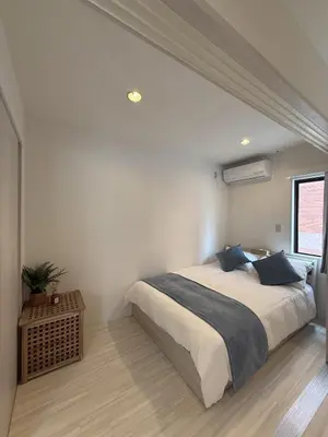 a bedroom with a large bed and a window at SKY inn 1F in Tokyo