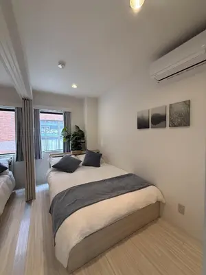a bedroom with a large bed in a room at SKY inn 1F in Tokyo