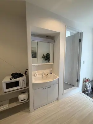 a bathroom with a sink and a microwave at SKY inn 1F in Tokyo