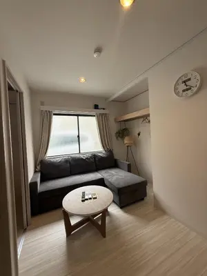 a living room with a couch and a table at SKY inn 1F in Tokyo