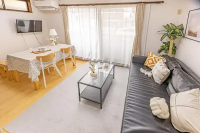 a living room with a couch and a table at Nishiikebukuro 3people, mansion,2 mins to subway in Tokyo