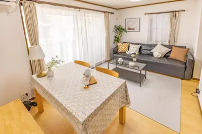 a living room with a table and a couch at Nishiikebukuro 3people, mansion,2 mins to subway in Tokyo