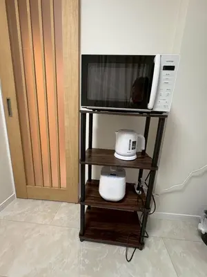 a microwave on a shelf next to a door at \u3055\u304f\u3089\u65c5\u9928\u9ad8\u5186\u5bfa\u5317\u5343\u5229\u4f11102\u53f7\u5ba4 in Tokyo