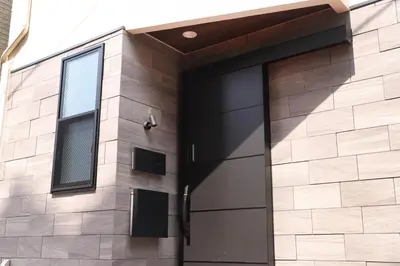 a black door on a brick building with a window at Shibuya house w Rooftop, 6min to Station, Skyline View in Tokyo