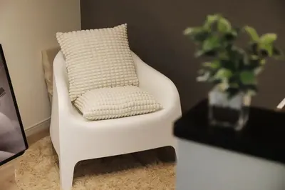 a white chair with a pillow in a living room at Shibuya house w Rooftop, 6min to Station, Skyline View in Tokyo