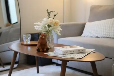 a coffee table with a vase of flowers on it at Shibuya house w Rooftop, 6min to Station, Skyline View in Tokyo