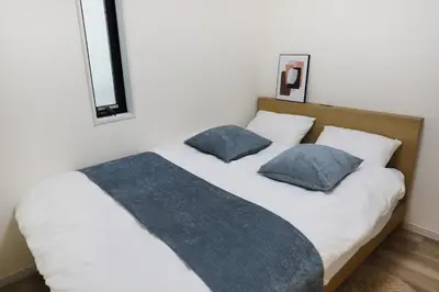 a bedroom with a bed with two pillows on it at Shibuya house w Rooftop, 6min to Station, Skyline View in Tokyo