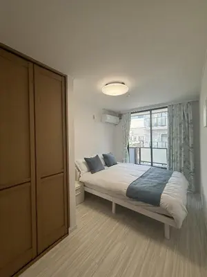 a bedroom with a bed and a large window at SKY inn 2-3F in Tokyo