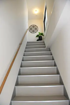 a staircase in a house with white walls and white stairs at SKY inn 2-3F in Tokyo