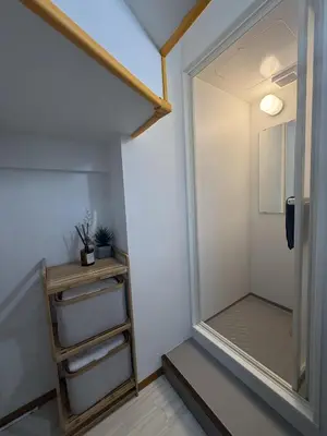 a walk in closet with a mirror in a room at SKY inn 2-3F in Tokyo