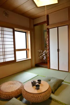 a room with a table and chairs and windows at SKY inn 2-3F in Tokyo