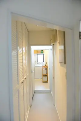 a hallway leading into a room with a door at SKY inn 2-3F in Tokyo