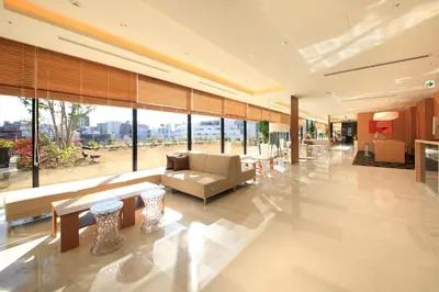 a lobby with a couch and tables and windows at Richmond Hotel Premier Asakusa International in Tokyo