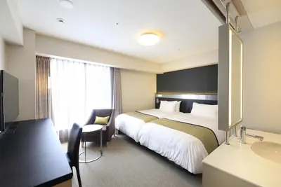 a hotel room with two beds and a sink at Richmond Hotel Premier Asakusa International in Tokyo