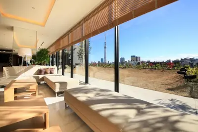 a living room with couches and a large window at Richmond Hotel Premier Asakusa International in Tokyo