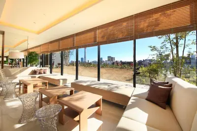 a lobby with couches and tables and large windows at Richmond Hotel Premier Asakusa International in Tokyo