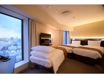 a hotel room with three beds and a large window at Richmond Hotel Premier Asakusa International in Tokyo
